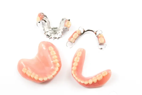 Upper and lower dentures displayed showing partial and full denture options