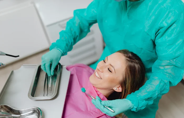 Young girl lying in dental chair smiling during dental examination