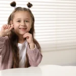 A child celebrating first tooth traditions with help from our Tacoma family dental team.