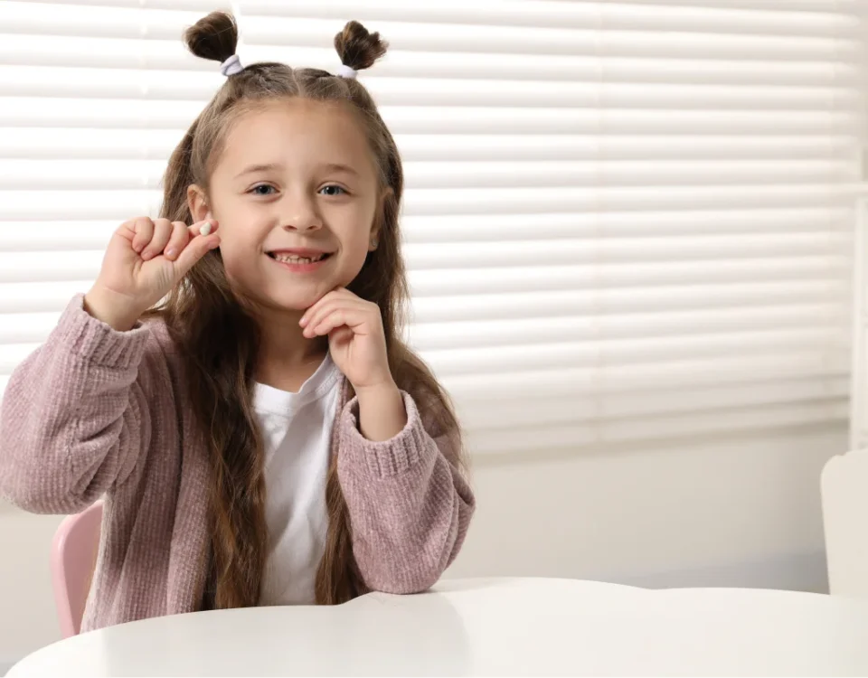 A child celebrating first tooth traditions with help from our Tacoma family dental team.