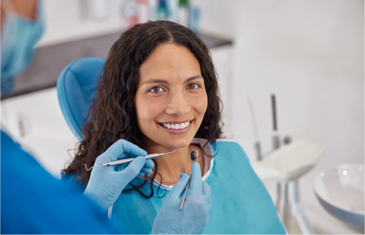 Patient in dental chair being examined by dentist during dental bridge consultation