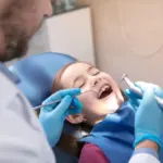 Child receiving back to school dental checkup at Davis Dental Group in Tacoma with dentist examining teeth