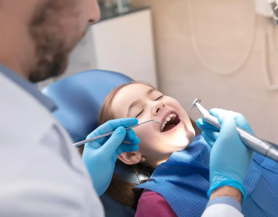 Child receiving back to school dental checkup at Davis Dental Group in Tacoma with dentist examining teeth