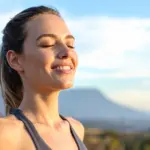 Woman breathing fresh air outdoors representing fresh breath solutions from Davis Dental Group in Tacoma