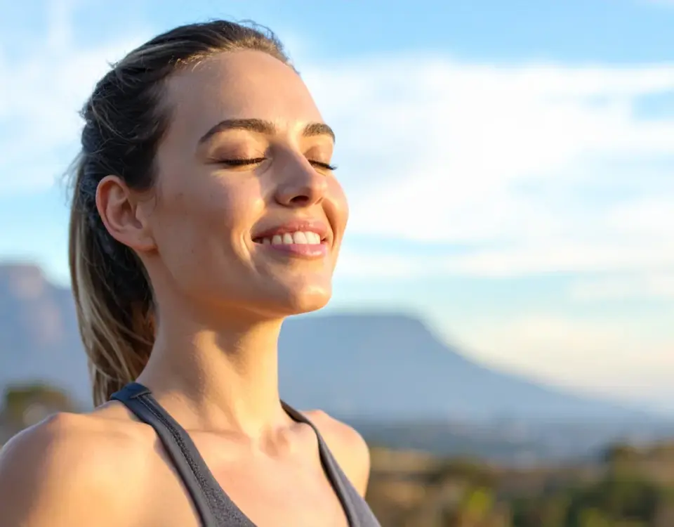 Woman breathing fresh air outdoors representing fresh breath solutions from Davis Dental Group in Tacoma