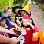 Kids in Halloween costumes eating candy — dental tips from Davis Dental Group Tacoma WA