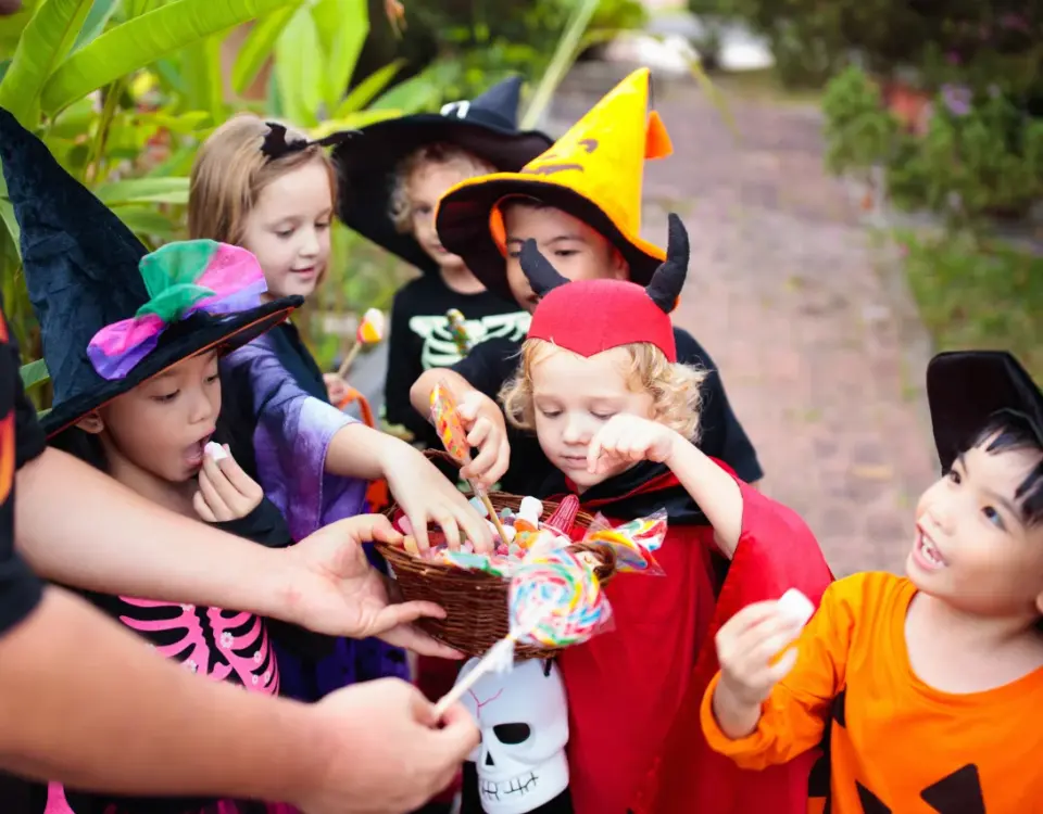 Kids in Halloween costumes eating candy — dental tips from Davis Dental Group Tacoma WA